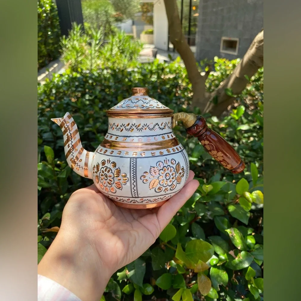 This handmade, white-painted Turkish copper teapot set features traditional